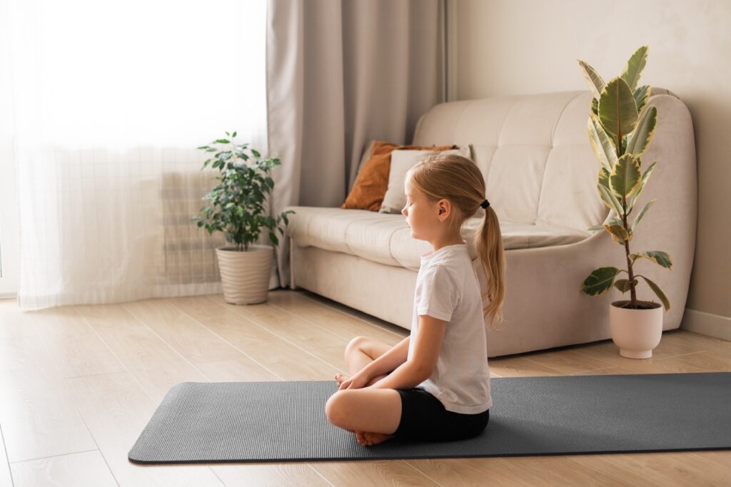 girl-sitting-in-yoga-meditation-kids-yoga-at-home-2023-11-27-05-11-31-utc